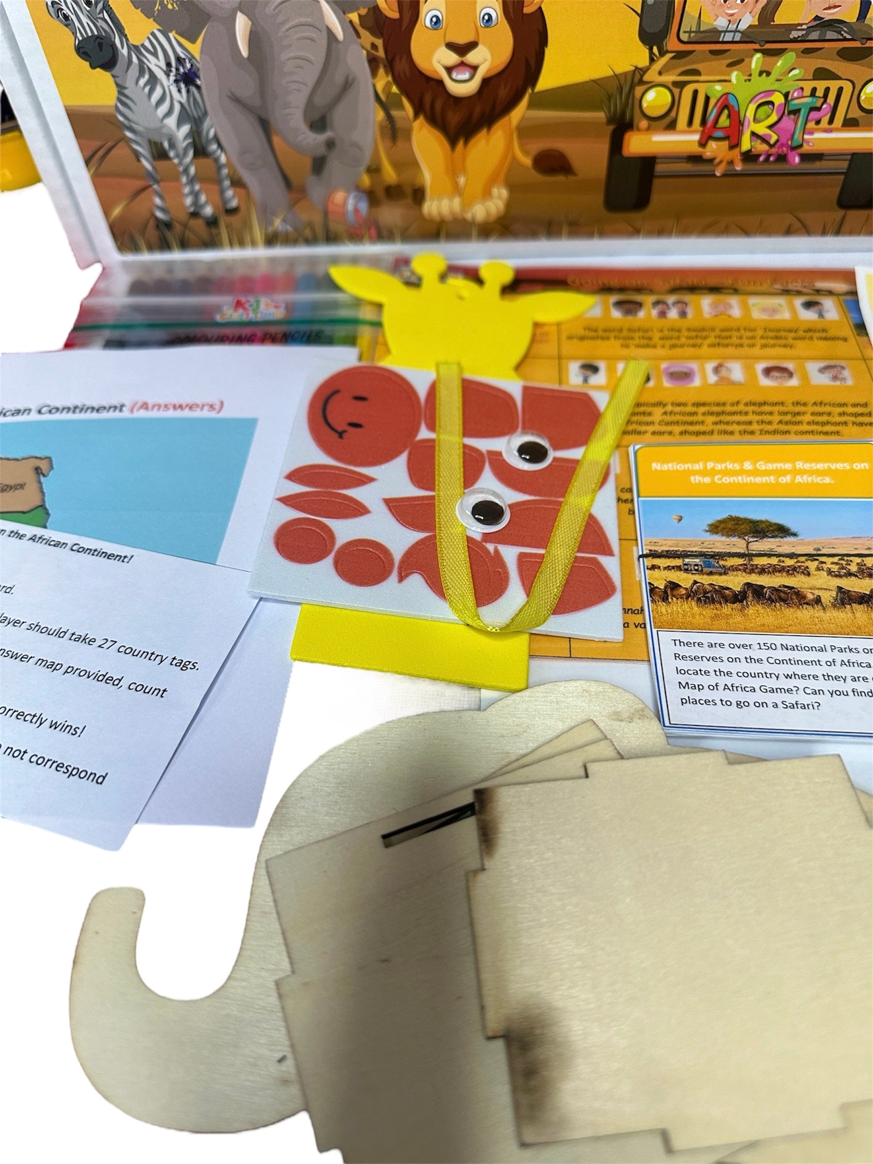 Close-up view of Safari Craft Box contents, showing safari pen pot, flashcards, animal bookmark materials, and fun fact sheet.