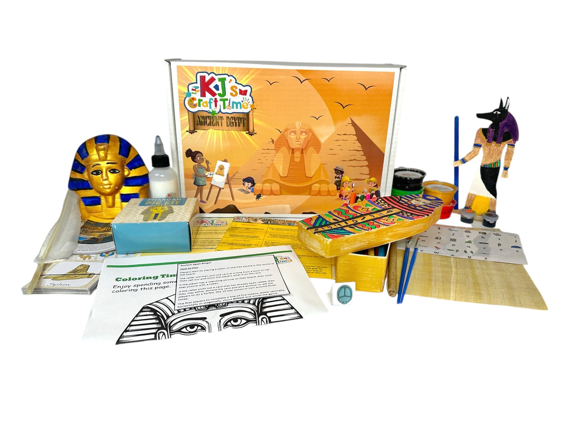 Front view of the Ancient Egypt Craft Box for kids, featuring completed crafts like the Sphinx coin bank and sarcophagus pencil box, along with materials like the Egyptian mummy dig kit, Ancient Egypt bingo game, and activity sheets.