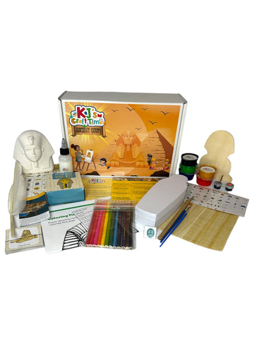 Front view of the Ancient Egypt Craft Box for kids with materials like Sphinx coin bank, mummy dig kit, and papyrus paper displayed.