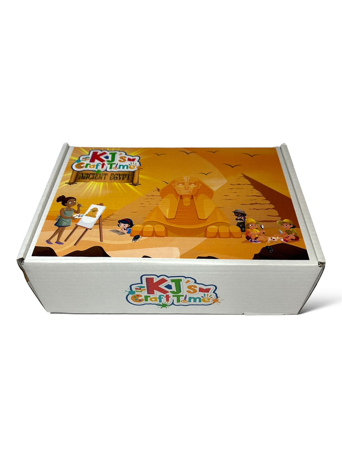 Front view of the Ancient Egypt Craft Box for kids with materials like Sphinx coin bank, mummy dig kit, and papyrus paper displayed.