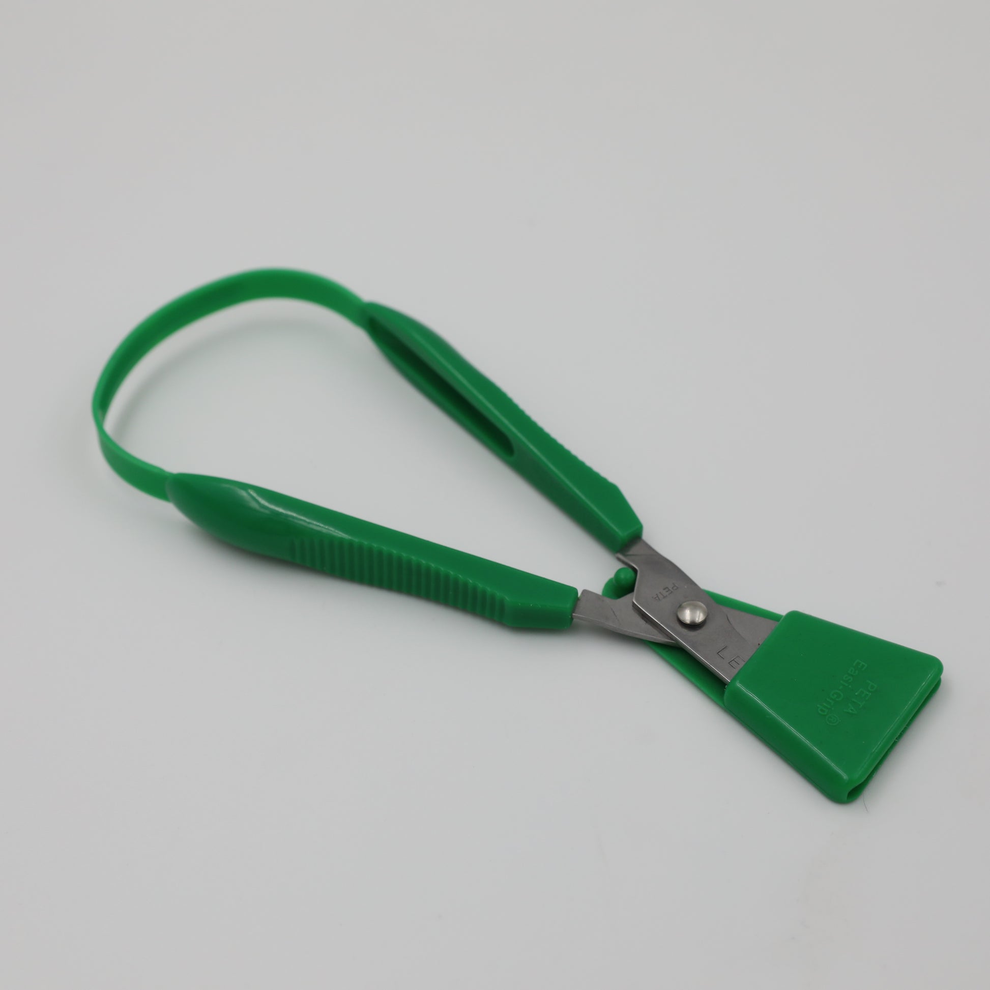 Green left-handed Easi-Grip Scissors with blade guard on.