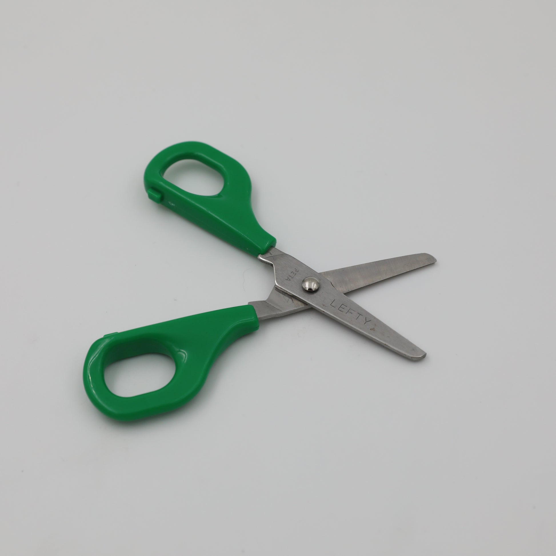 Left-handed green Child Self-Opening Scissors open.