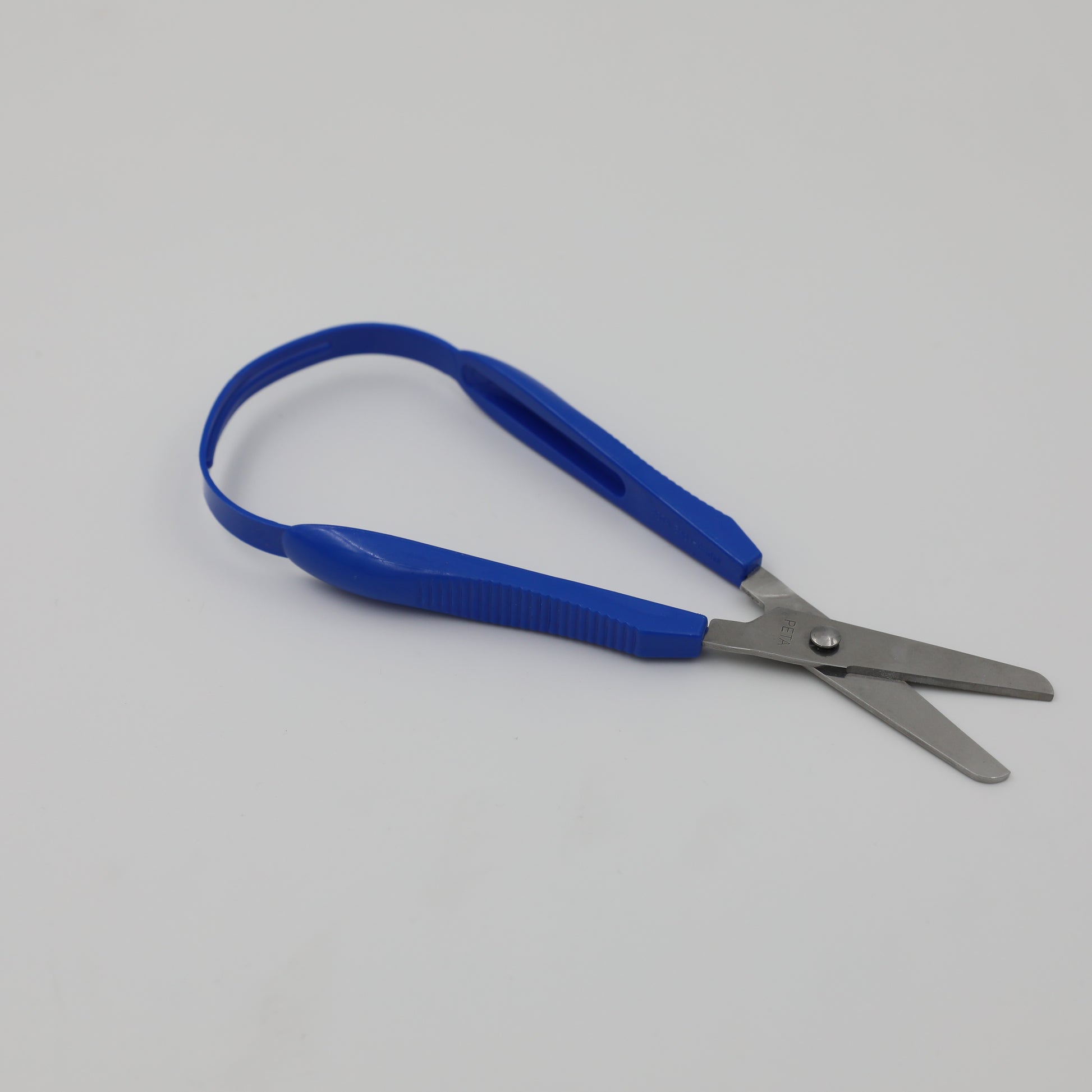 Blue right-handed Easi-Grip Scissors lying open.