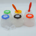 Four plastic cups with colored lids on a white background