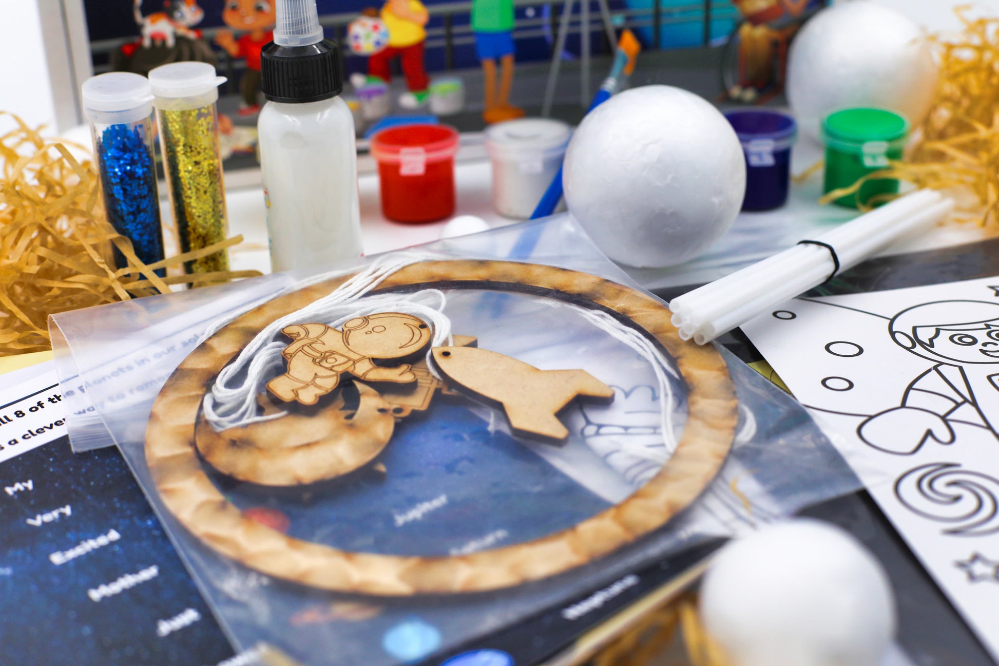 Wooden space-themed craft pieces and hanging activity included in the Space Craft Kit for hands-on creative play.