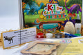 Close-up of dinosaur craft kit materials including educational dinosaur flashcards, paint pots and craft supplies
