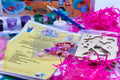 Close-up of mermaid craft kit contents including wooden lantern pieces, beads, mermaid keyring craft, magnet craft and themed activity sheets.