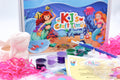 Mermaid craft kit for kids showing ceramic flowerpot, mermaid themed paints, paintbrushes and activity sheets from KJ’s Craft Time Mermaid Craft Box.