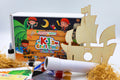 Pirate craft kit for kids laid out with box and hands-on activities, perfect for creative play, birthdays and pirate-themed gifts.